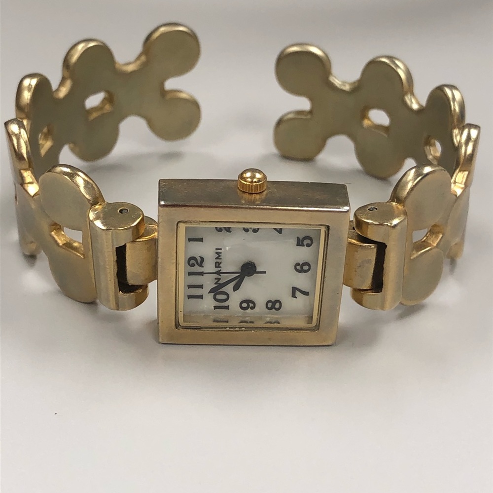 Brushed gold tone puzzle piece cuff bracelet